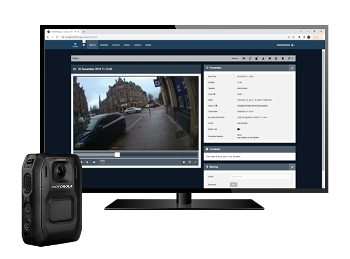 Motorola Solutions VideoManager software visible on a desktop monitor with V500 Body Worn Camera in front